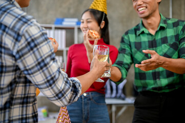 Group of happy asian friends enjoying the party together, laughing, clinking glasses with wine.