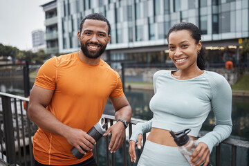 Fototapeta na wymiar Black couple, portrait and fitness in urban city, workout partner with water bottle for hydration and relax after exercise. Happy black man with black woman and wellness, active lifestyle in Chicago.