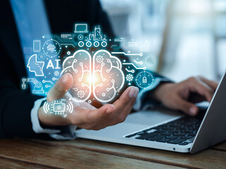 Artificial Intelligence concept (AI). Futuristic virtual graphics of digital brain circuit, management processes systems, machines elements technology appear in human hand while using laptop computer.