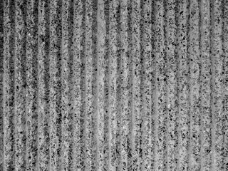 Abstract corrugated concrete wall texture background. Modern terrazzo stone wallpaper with vertical stripped pattern, black and white. Modern cement surface construction with waving pattern, top view.