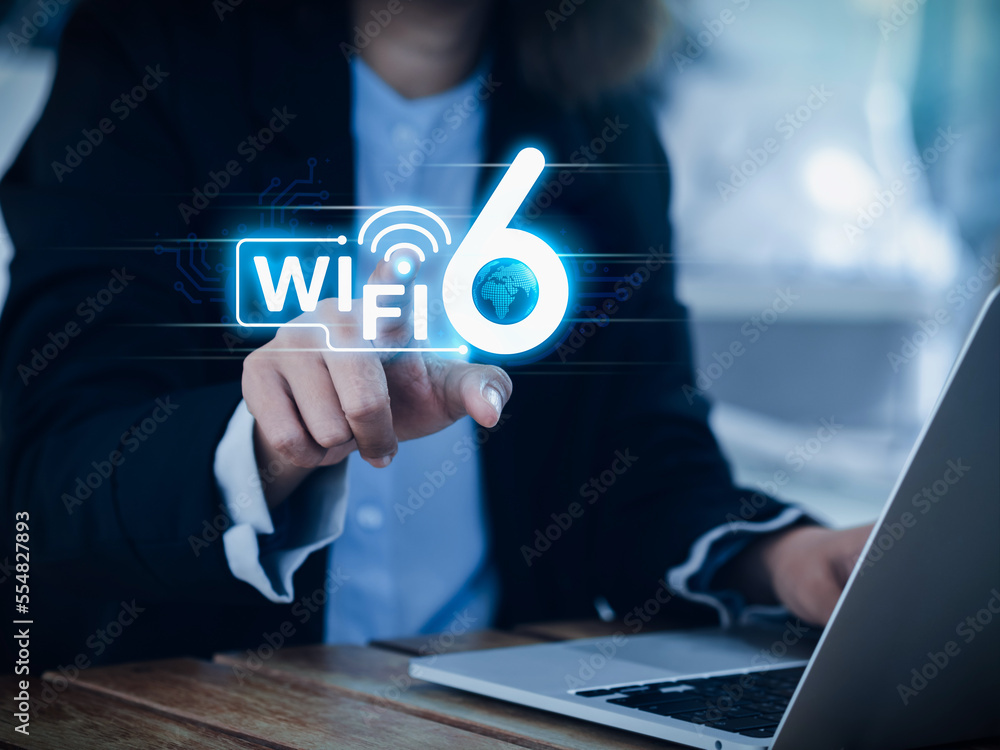 Poster wi-fi 6 speed logo glowing on virtual screen while businesswoman pointing hand and using laptop comp