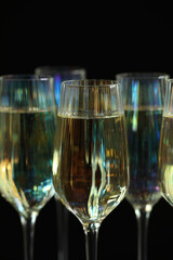 Glasses of champagne on black background, closeup