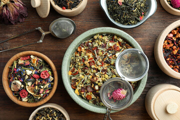 Many different herbal teas on wooden table, flat lay