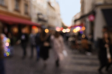 Naklejka premium Blurred view of people walking on city street