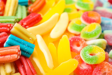 Tasty colorful jelly candies as background, closeup view