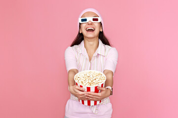 woman watching comedy holding bucket of popcorn