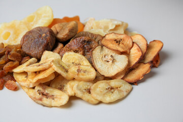 Pile of different dried fruits on white background, closeup
