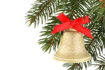 Christmas bell with red bow hanging on fir tree branch against white background