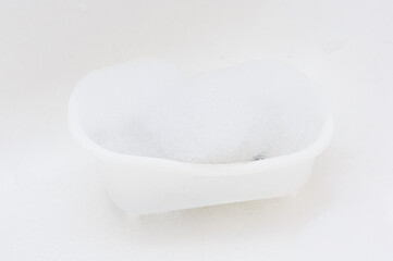 Beautiful white bubble bath. Minimalism concept. Copy space. Close up