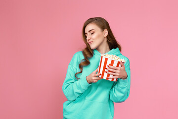 girl watching movie film, holding bucket of popcorn