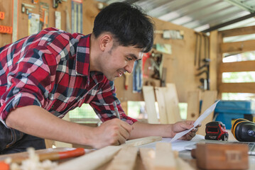 person doing diy project at home. Man measuring wood to doing cabinet craftworks as a hobby.