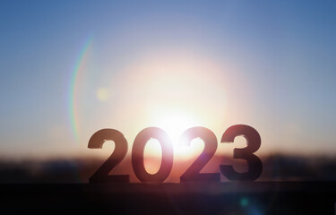 Bright rising sun background and happy and hopeful new year sunrise landscape in 2023
