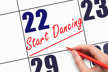 22nd day of the month.  Hand writing text START DANCING and drawing a line on calendar date.