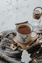 Winter tea in the white mug with reindeer