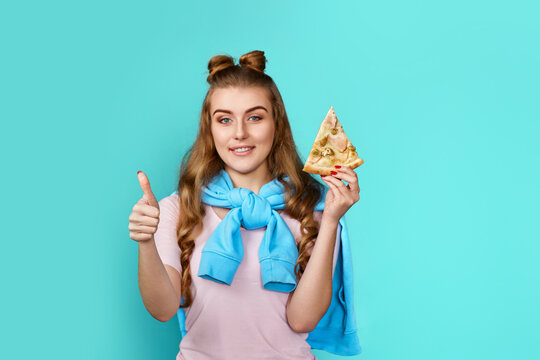 woman eating delicious pizza slice and showing ok gesture