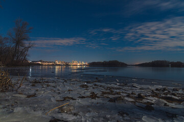 Fototapeta na wymiar Scenic view of the city of Dnepr in the winter evening. Dnipro in the evening. Ukrainian city in winter at night. background image. Panoramic view. Long exposure photo of the Dnieper River at night.