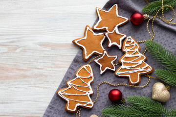 festive gingerbread decorated with icing lie on a light wooden background.Top view