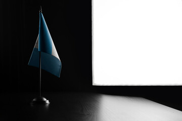 Small national flag of the Guatemala on a black background