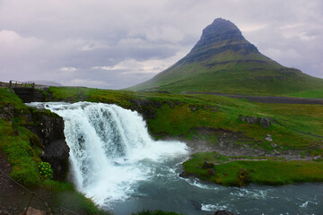Lanscape of mountain and waterfall in cloudy sky. Famous Kirkjufelfoss  cascade