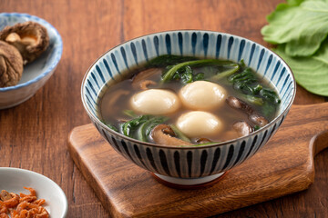 Eating big tangyuan yuanxiao with savory soup in Taiwan.