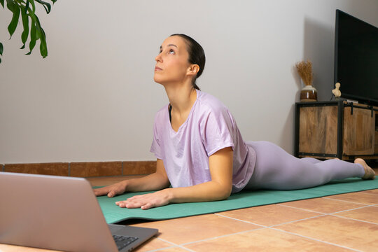 yoga. Girl doing yoga exercises at home. Sphinx position