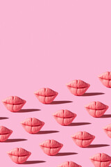Pattern from pink lips on pink background. Creative beauty concept vertical background