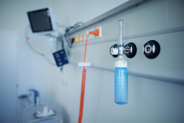Close-up of oxygen flowmeter in hospital room.