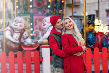 Happy caucasian couple in love on date walking city streets Christmas fair time over light bokeh. Pastime together. Romantic, love family and greeting concept New Year winter. Copy space