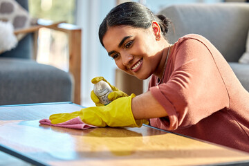 Woman, wipe table and spray with cloth, for hygiene and disinfectant in home. Cleaner, maid or...