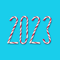 2023, Number made up of Christmas candies. Isolated on a blue background. Holidays. New Year.