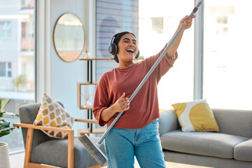 Dance, radio or woman cleaning with music for singing or listening to a song with broom as a guitar...