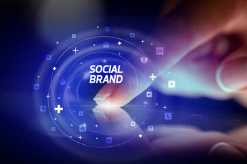Finger touching tablet with social media icons concept