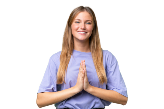 Young beautiful woman over isolated background keeps palm together. Person asks for something