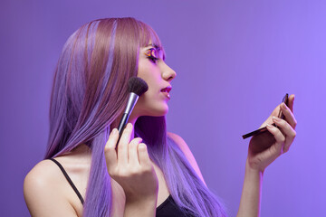 a beautiful woman is wearing eye shadow while standing on a purple background in a purple wig and fashionable clothes