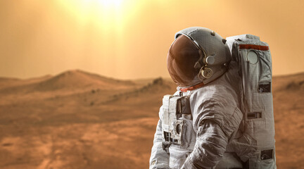 Astronaut on Mars. Martian expedition. Spaceman on red planet. Elements of this image furnished by NASA