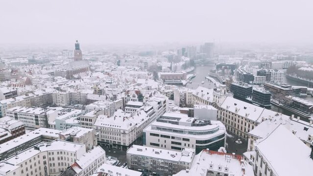 Winter aerial view with snowfall on old city of Wroclaw and St Elizabeth of Hungary Roman Catholic parish 4k