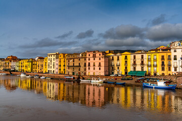Fototapeta na wymiar colorful houses and fishing boats on the waterfront of Bosa on the River Terno