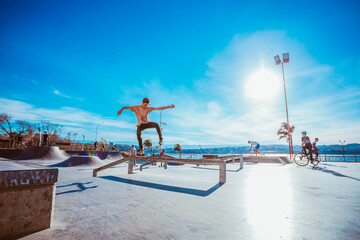 Young man doing skateboarding trick. Teenager at skatepark on a skateboard.