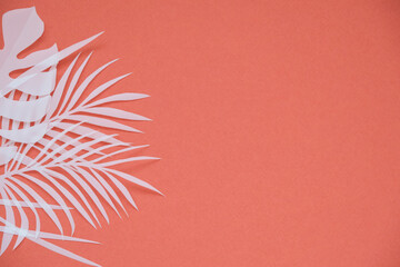 Fototapeta na wymiar Tropical palm leaf on red background. Flat lay, top view 