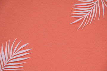 Tropical palm leaf on red background. Flat lay, top view	