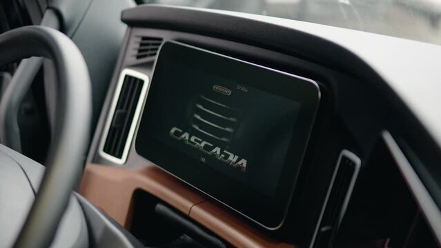 new freightliner cascadia Volvo 2023 starting engine and screen turning on. Close up dashboard