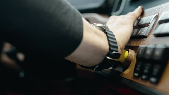 Truck driver pushing with hand parking break knob then releasing to apply of a new freightliner cascadia volvo 2023.No face