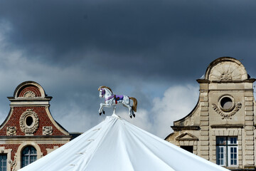 wooden horse of a manege and pediment of the house in Arras, France.