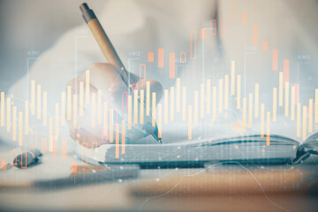 Multi exposure of woman's hands making notes with forex graph hologram. Concept stock market analysis.