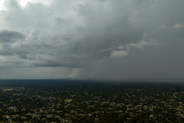Landscape of dark ominous clouds forming on stormy sky during heavy thunderstorm over rural town...