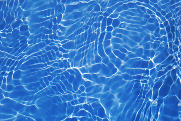 Defocus blurred transparent blue colored clear calm water surface texture with splashes and bubbles. Trendy abstract nature background. Water waves in sunlight with caustics. Blue water shinning 