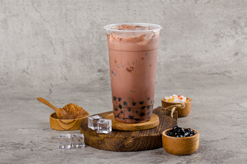 Boba or tapioca pearls is taiwan bubble milk tea in plastic cup with dark chocolate flavor on...