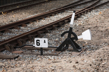 A close-up of an old and manual operated siding along a railroad track
