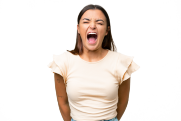 Young caucasian woman isolated on green chroma background shouting to the front with mouth wide open