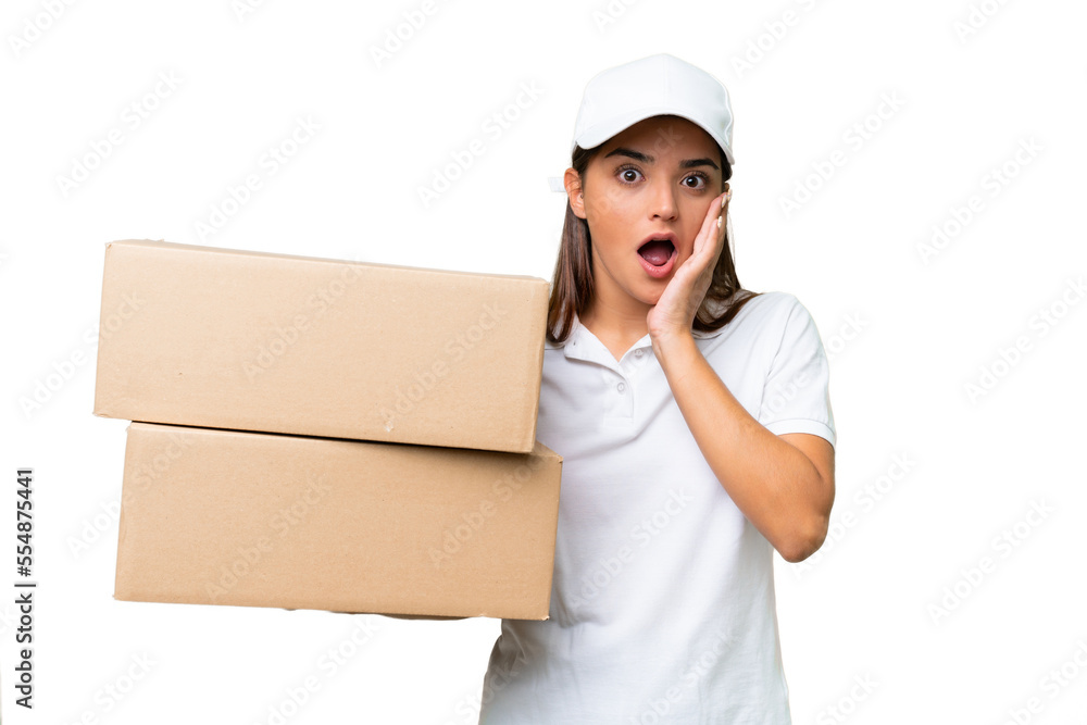 Wall mural Delivery caucasian woman holding boxes isolated on green chroma background with surprise and shocked facial expression